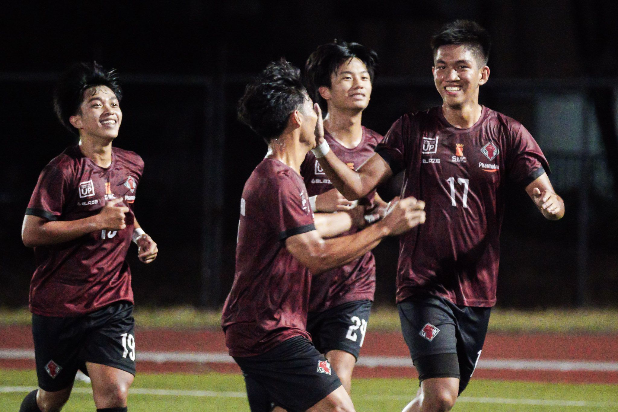 The UP Fighting Maroons celebrate Lorenz Tortona's goal against University of Santo Tomas in the UAAP Season 86 men's football tournament, April 28, 2024 at the UP Diliman Football Stadium. UAAP Media